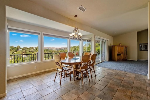 8412 Alta Vista Ave, Atascadero, CA 93422 - dining room with a chandelier, vaulted ceiling, and stone finish floors