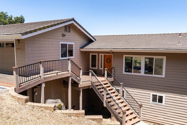 8412 Alta Vista Ave, Atascadero, CA 93422 - rear view of house with stairs, a tiled roof, a wooden deck, and an attached garage