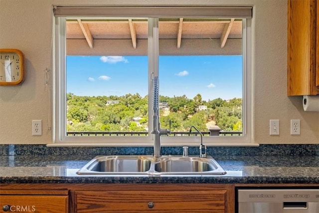 8412 Alta Vista Ave, Atascadero, CA 93422 - kitchen with stainless steel dishwasher, brown cabinets, healthy amount of natural light, and a textured wall