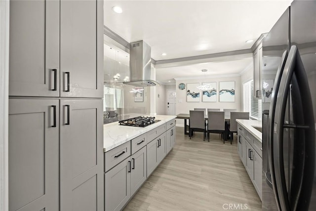 1834 E Stuart Ave, West Covina, CA 91791 - kitchen featuring freestanding refrigerator, island exhaust hood, gas cooktop, crown molding, and gray cabinets