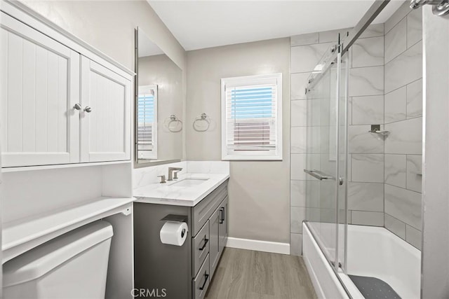 1834 E Stuart Ave, West Covina, CA 91791 - bathroom featuring vanity, wood finished floors, and bath / shower combo with glass door
