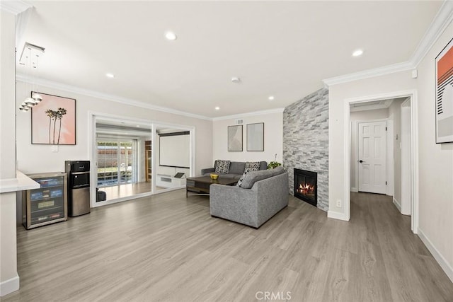 1834 E Stuart Ave, West Covina, CA 91791 - living room with light wood-type flooring, crown molding, beverage cooler, a stone fireplace, and recessed lighting