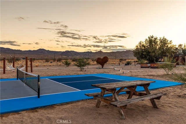 5725 Sunfair Rd, Joshua Tree, CA 92252 - surrounding community with a mountain view and a tennis court