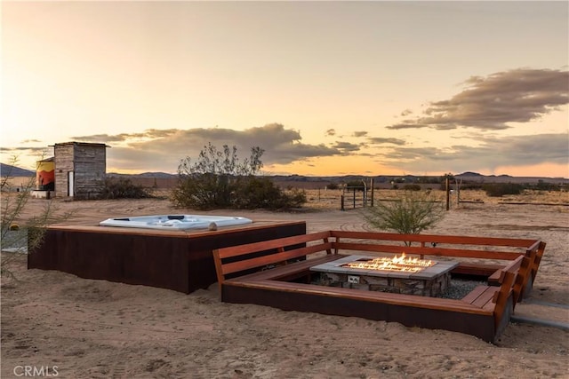 5725 Sunfair Rd, Joshua Tree, CA 92252 - yard at dusk with a fire pit