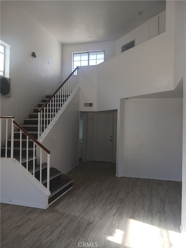 44738 Foxboro Ct, Lancaster, CA 93535 - entrance foyer featuring wood finished floors, stairway, and a towering ceiling