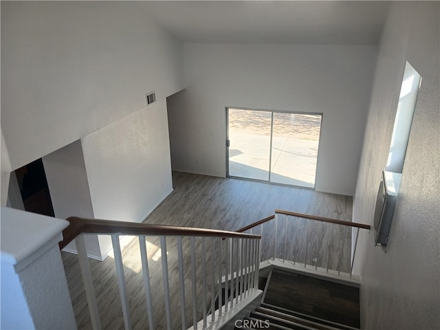 44738 Foxboro Ct, Lancaster, CA 93535 - staircase featuring wood finished floors and high vaulted ceiling