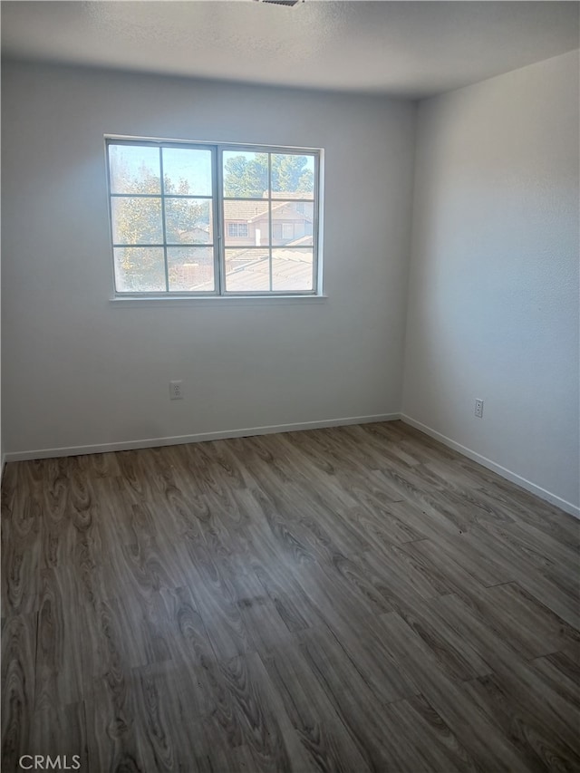 44738 Foxboro Ct, Lancaster, CA 93535 - empty room with dark wood-style flooring and baseboards