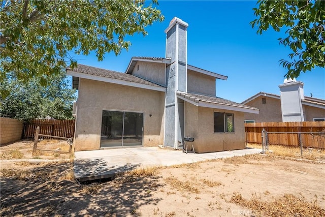 44738 Foxboro Ct, Lancaster, CA 93535 - back of house featuring a fenced backyard, stucco siding, a patio area, and a tiled roof