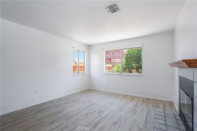 44738 Foxboro Ct, Lancaster, CA 93535 - unfurnished living room with a fireplace with flush hearth and wood finished floors