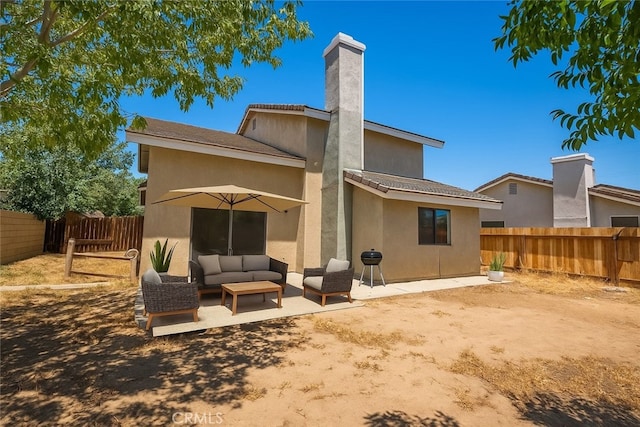 44738 Foxboro Ct, Lancaster, CA 93535 - back of house with outdoor lounge area, a fenced backyard, a patio area, a chimney, and stucco siding