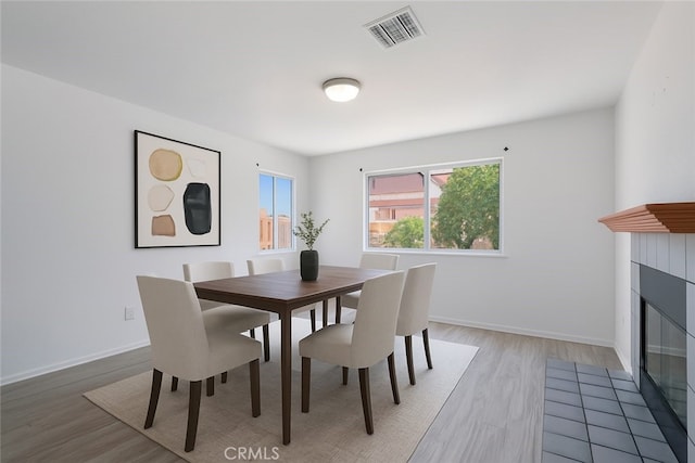 44738 Foxboro Ct, Lancaster, CA 93535 - dining room featuring light wood-style floors and a fireplace