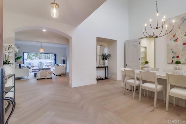 2850 Palmetto Point Ct, Chula Vista, CA 91915 - dining area featuring arched walkways, a chandelier, and a towering ceiling
