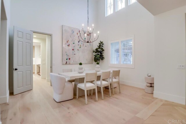 2850 Palmetto Point Ct, Chula Vista, CA 91915 - dining room with a towering ceiling, a chandelier, and light wood-style floors