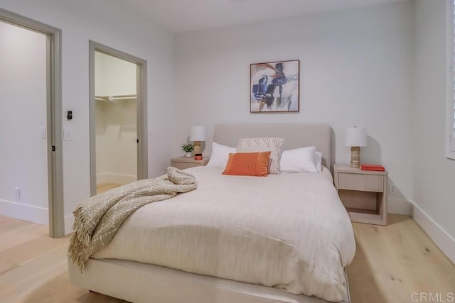 2850 Palmetto Point Ct, Chula Vista, CA 91915 - bedroom with light wood-style flooring and a walk in closet