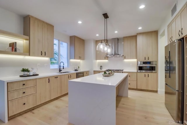 2850 Palmetto Point Ct, Chula Vista, CA 91915 - kitchen with stainless steel appliances, wall chimney exhaust hood, light brown cabinets, light wood finished floors, and light countertops