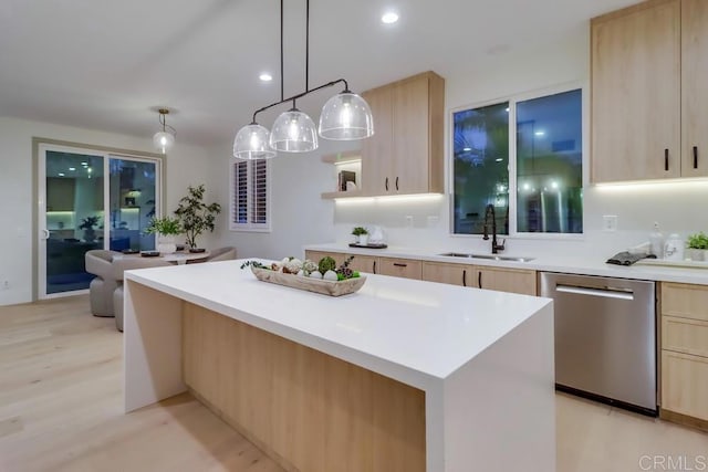 2850 Palmetto Point Ct, Chula Vista, CA 91915 - kitchen with stainless steel dishwasher, light brown cabinetry, light countertops, a kitchen island, and light wood-style flooring