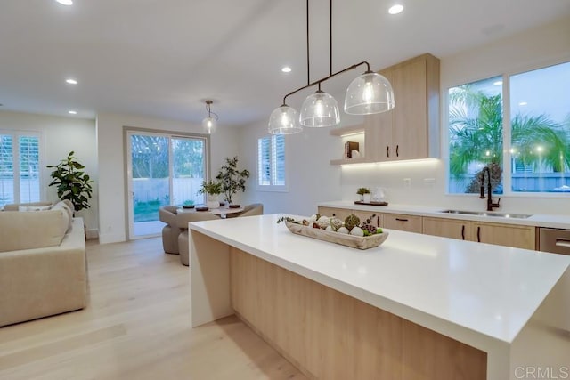 2850 Palmetto Point Ct, Chula Vista, CA 91915 - kitchen featuring light brown cabinetry, open floor plan, light countertops, recessed lighting, and light wood-style flooring
