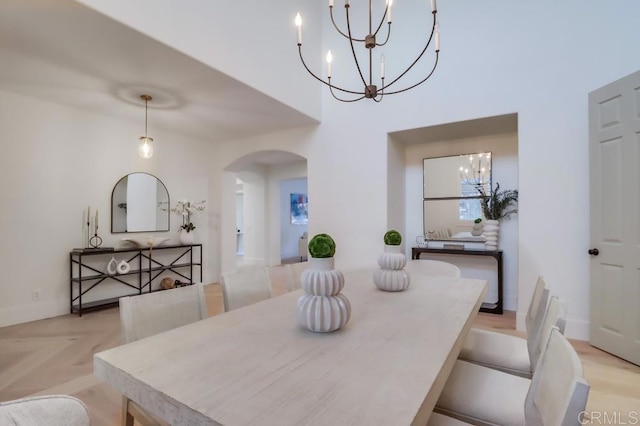 2850 Palmetto Point Ct, Chula Vista, CA 91915 - dining area featuring a chandelier, arched walkways, and a high ceiling