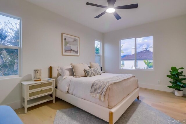 2850 Palmetto Point Ct, Chula Vista, CA 91915 - bedroom featuring multiple windows, light wood-style floors, and a ceiling fan