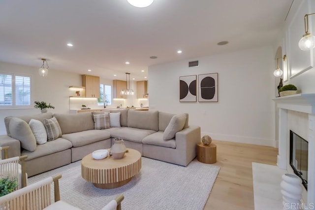 2850 Palmetto Point Ct, Chula Vista, CA 91915 - living area with recessed lighting, a fireplace with flush hearth, and light wood-style flooring