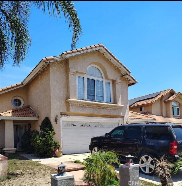 23830 Swan St, Moreno Valley, CA 92557 - view of front facade with a tiled roof, stucco siding, and a garage
