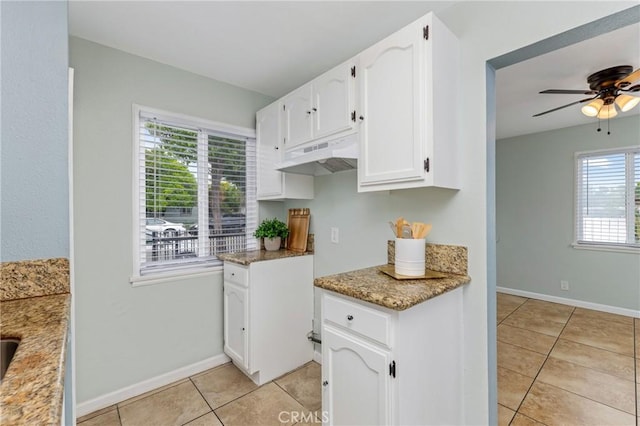 1048 S Record Ave, East Los Angeles, CA 90023 - kitchen featuring under cabinet range hood, light tile patterned floors, white cabinets, a ceiling fan, and light stone counters