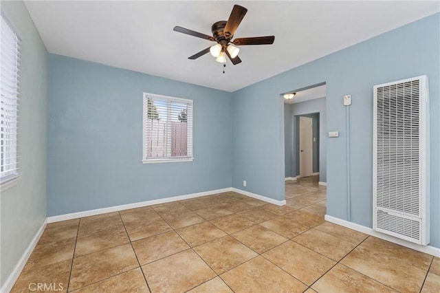 1048 S Record Ave, East Los Angeles, CA 90023 - unfurnished room featuring a heating unit, ceiling fan, and light tile patterned floors