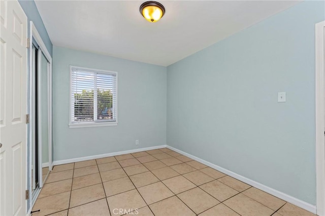 1048 S Record Ave, East Los Angeles, CA 90023 - unfurnished bedroom featuring a closet and light tile patterned floors
