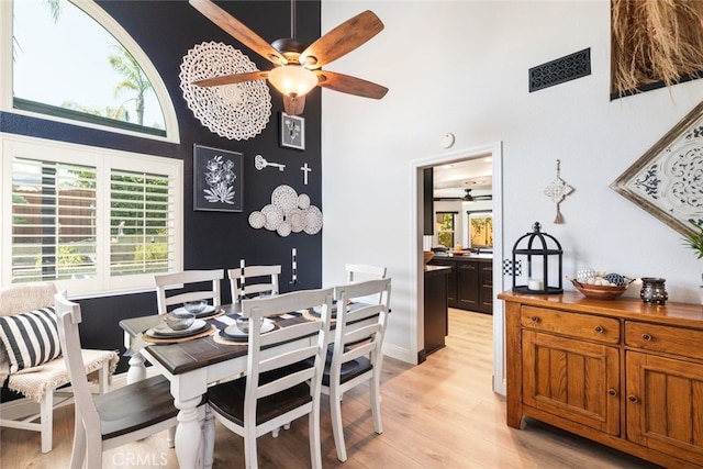 16508 Nectarine Way, Lake Elsinore, CA 92530 - dining area with a ceiling fan, a high ceiling, light wood-type flooring, and healthy amount of natural light