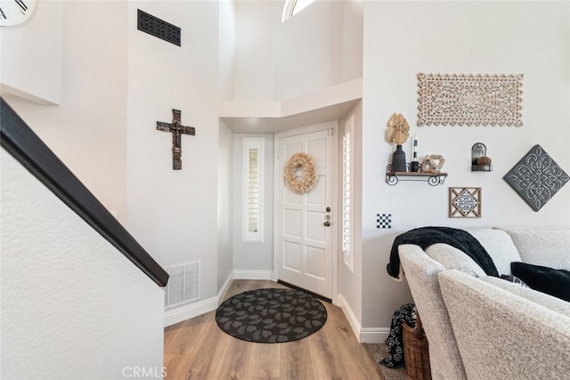 16508 Nectarine Way, Lake Elsinore, CA 92530 - entryway with a wall mounted air conditioner, wood finished floors, and a towering ceiling