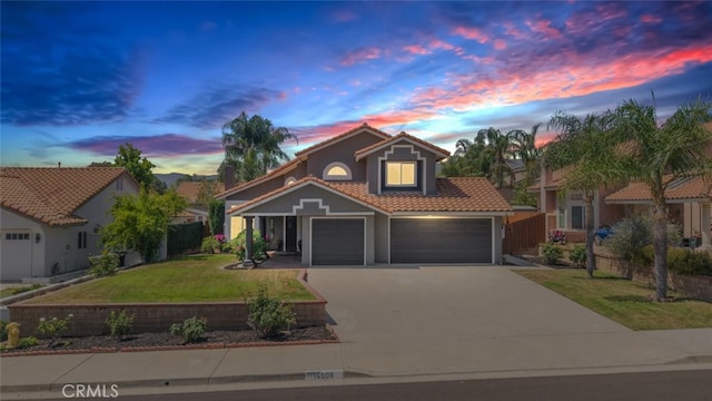16508 Nectarine Way, Lake Elsinore, CA 92530 - view of front of home featuring a tiled roof, driveway, stucco siding, and an attached garage