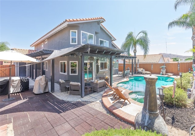16508 Nectarine Way, Lake Elsinore, CA 92530 - rear view of property featuring a pergola, a fenced backyard, stucco siding, and an outdoor hangout area