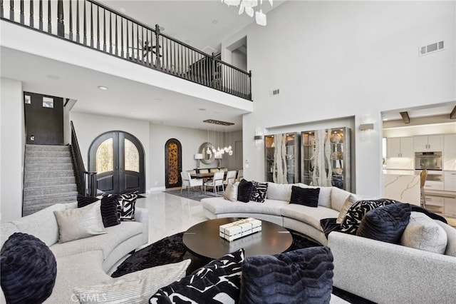 36472 County Line Rd, Yucaipa, CA 92399 - living room featuring marble tiled flooring, a towering ceiling, stairway, and a chandelier