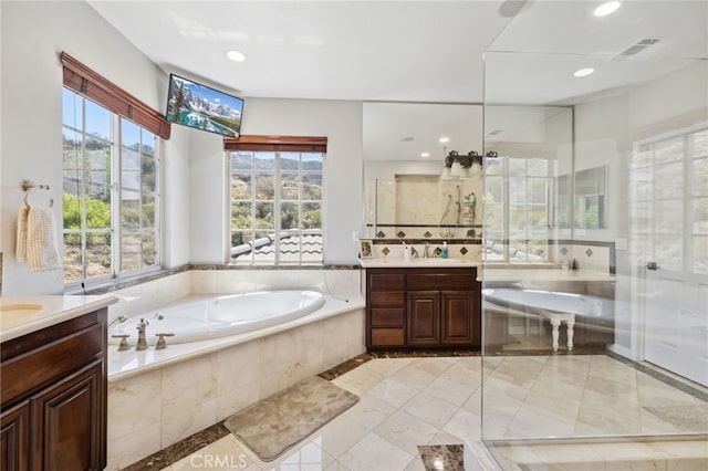 36472 County Line Rd, Yucaipa, CA 92399 - full bathroom featuring vanity, a bath, a stall shower, and recessed lighting