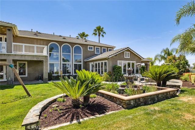 36472 County Line Rd, Yucaipa, CA 92399 - rear view of property with stucco siding, a lawn, and a balcony