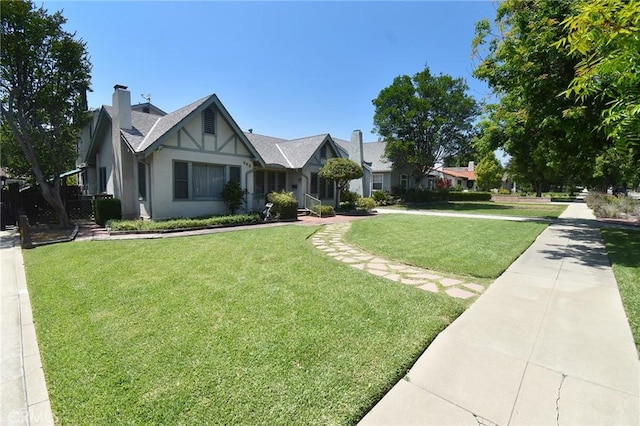 565 N Laurel Ave, Upland, CA 91786 - tudor-style house featuring a front lawn and stucco siding