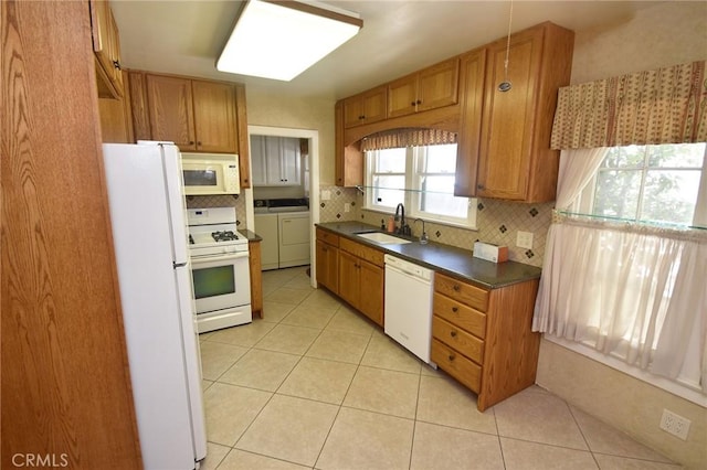 565 N Laurel Ave, Upland, CA 91786 - kitchen with white appliances, washer and dryer, tasteful backsplash, dark countertops, and brown cabinets