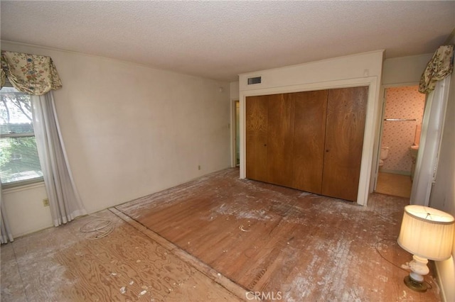 565 N Laurel Ave, Upland, CA 91786 - unfurnished bedroom with a closet and a textured ceiling