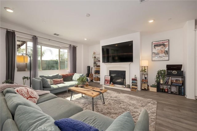 10963 Clementine Way, Loma Linda, CA 92354 - living room featuring wood finished floors, a glass covered fireplace, and recessed lighting