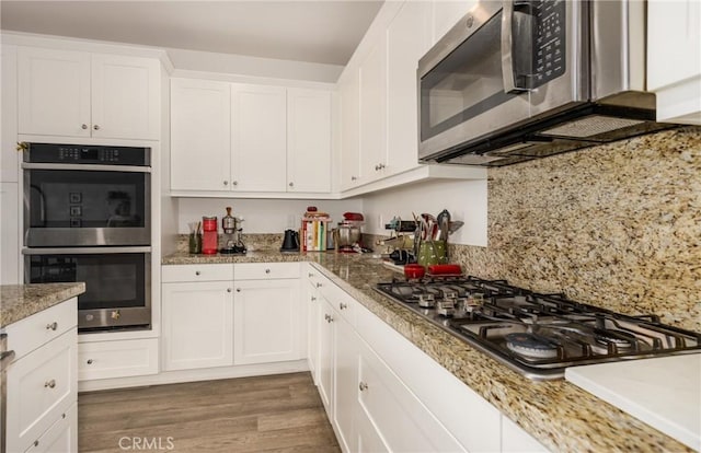 10963 Clementine Way, Loma Linda, CA 92354 - kitchen with stainless steel appliances, white cabinetry, and wood finished floors
