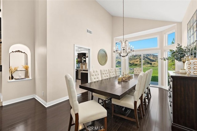 11900 Laughton Way, Porter Ranch, CA 91326 - dining room featuring high vaulted ceiling, dark wood-type flooring, and a chandelier