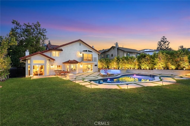 11900 Laughton Way, Porter Ranch, CA 91326 - back of property featuring an in-ground hot tub, a tiled roof, a patio, stucco siding, and a chimney