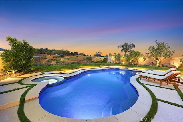 11900 Laughton Way, Porter Ranch, CA 91326 - pool at dusk featuring a pool with connected hot tub and a patio area