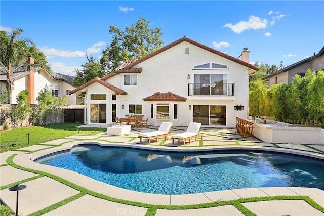 11900 Laughton Way, Porter Ranch, CA 91326 - back of house featuring a balcony, stucco siding, an outdoor pool, and a patio