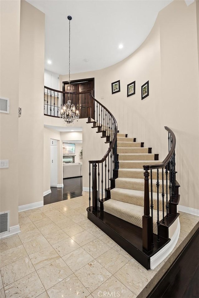 11900 Laughton Way, Porter Ranch, CA 91326 - stairs featuring recessed lighting, a high ceiling, and a chandelier