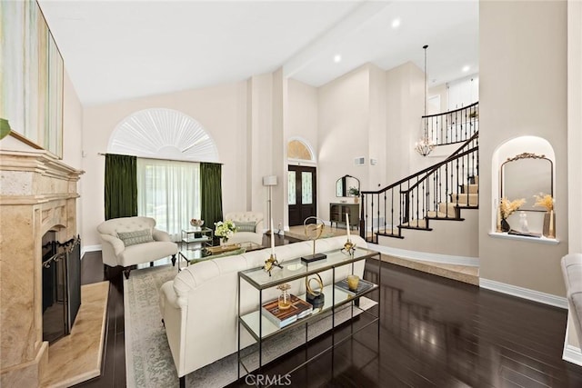 11900 Laughton Way, Porter Ranch, CA 91326 - living area with wood finished floors, high vaulted ceiling, a premium fireplace, and stairs