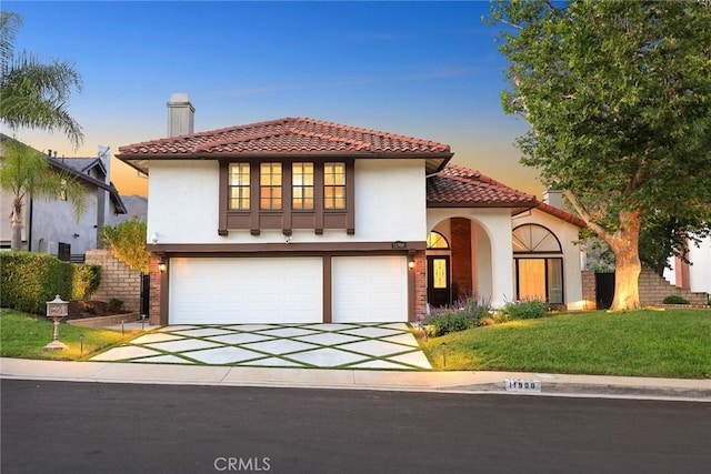 11900 Laughton Way, Porter Ranch, CA 91326 - mediterranean / spanish-style house with a garage, stucco siding, concrete driveway, a tiled roof, and a yard