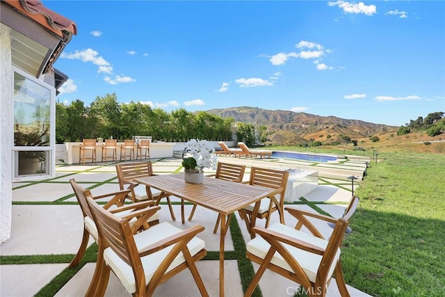 11900 Laughton Way, Porter Ranch, CA 91326 - view of patio / terrace with a mountain view, an outdoor pool, and outdoor dining area