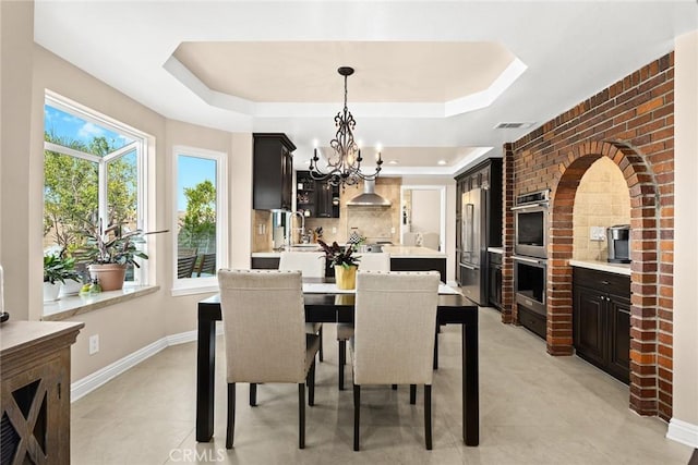 11900 Laughton Way, Porter Ranch, CA 91326 - dining area with a tray ceiling and a chandelier