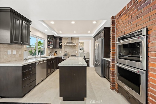 11900 Laughton Way, Porter Ranch, CA 91326 - kitchen with stainless steel appliances, a kitchen island, decorative backsplash, recessed lighting, and a raised ceiling